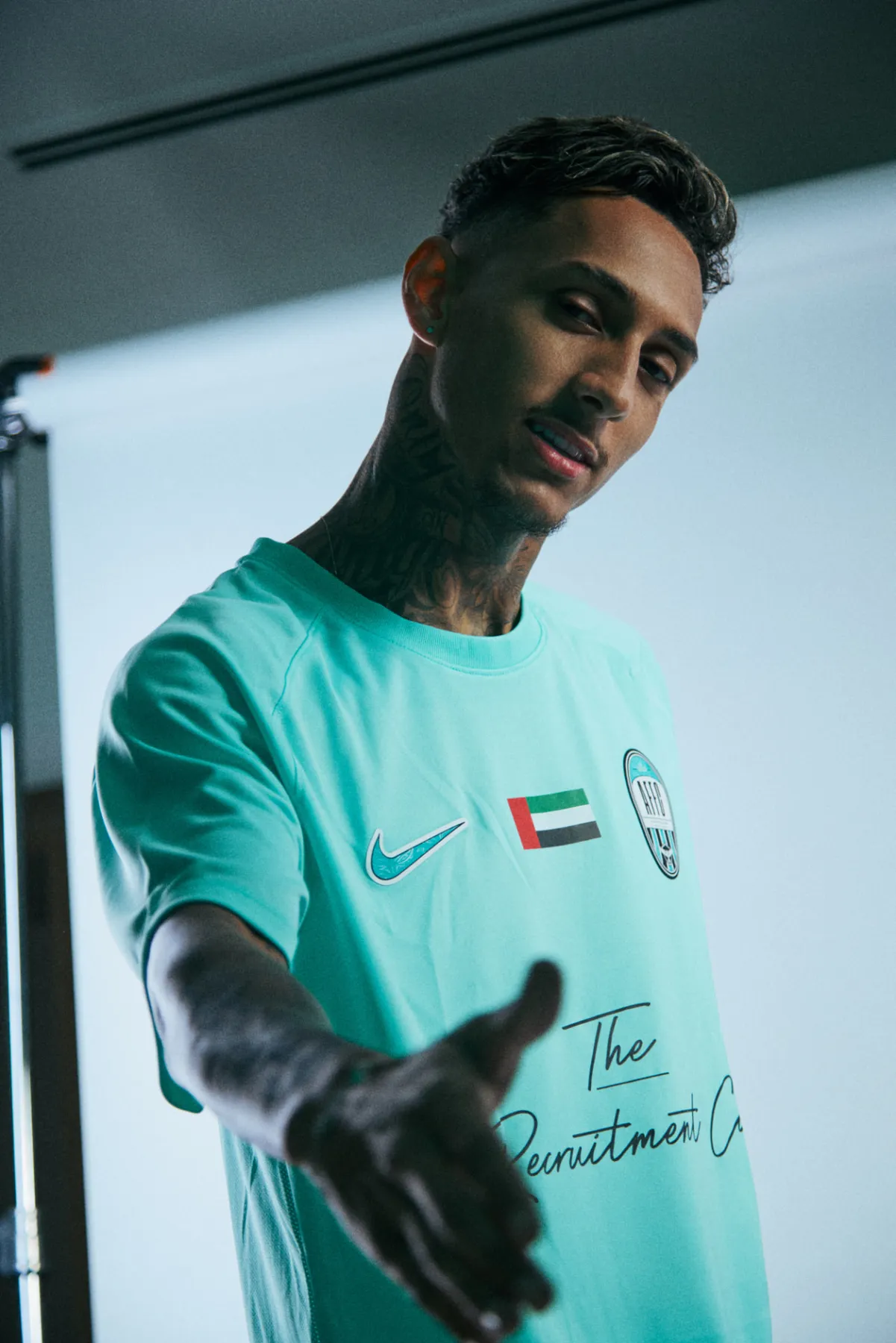 Arabian Falcons FC senior player reaching towards the camera